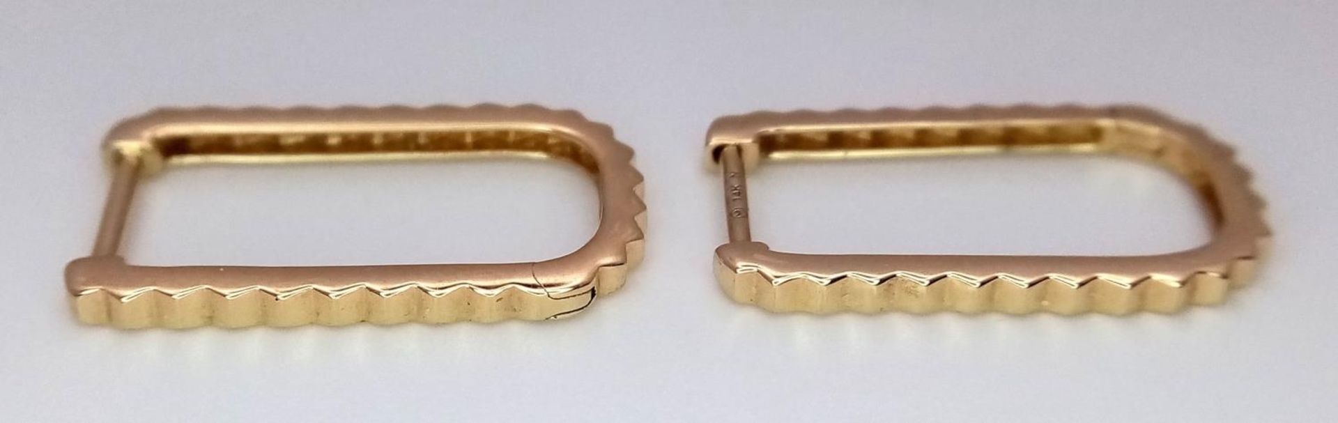 A Pair of Designer 14K Gold and Diamond Massika Rectangular Earrings. 1.7g total weight. - Image 2 of 4