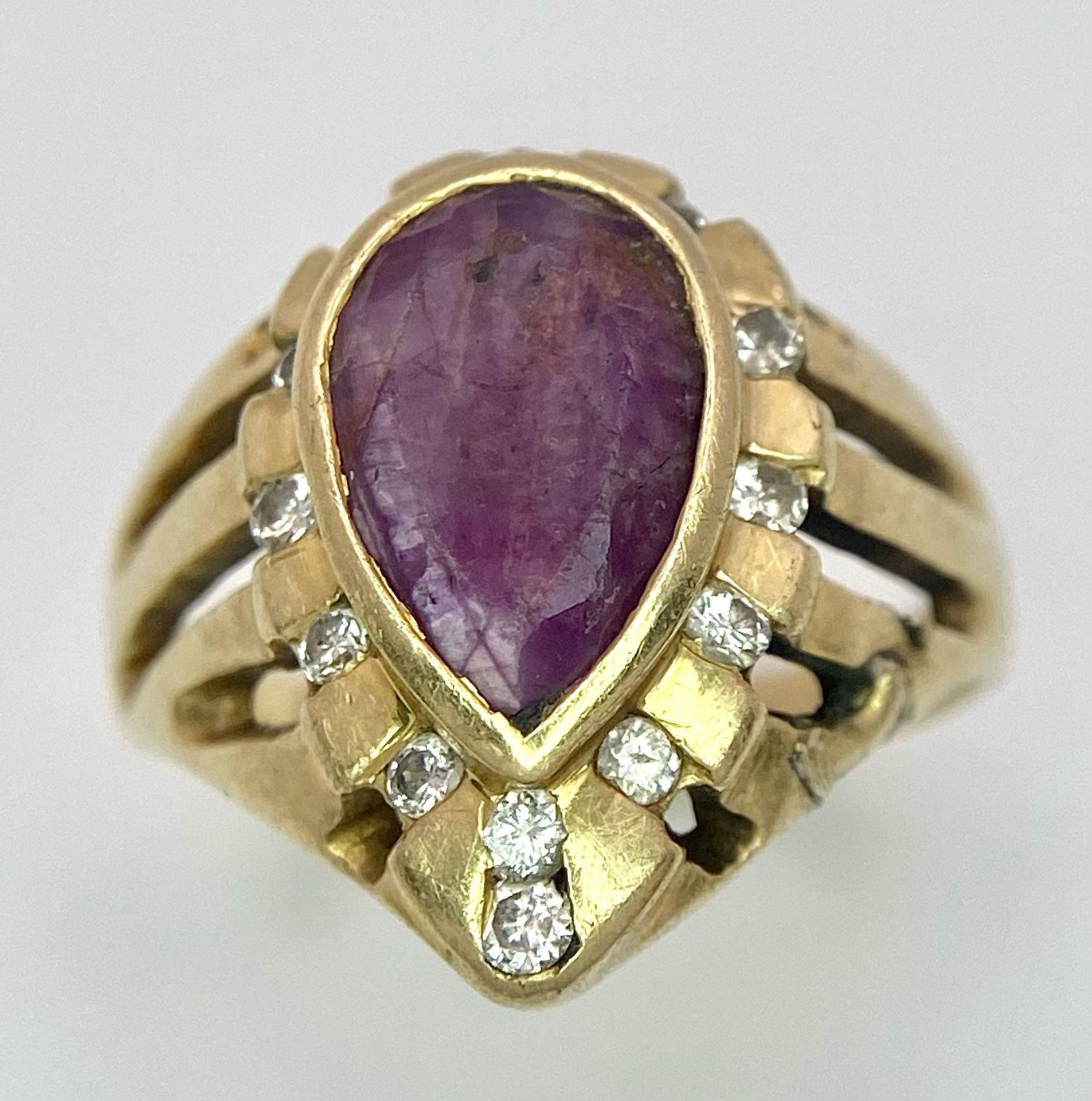 A Vintage 14K Yellow Gold Amethyst and Diamond Ring. Teardrop central amethyst with a diamond