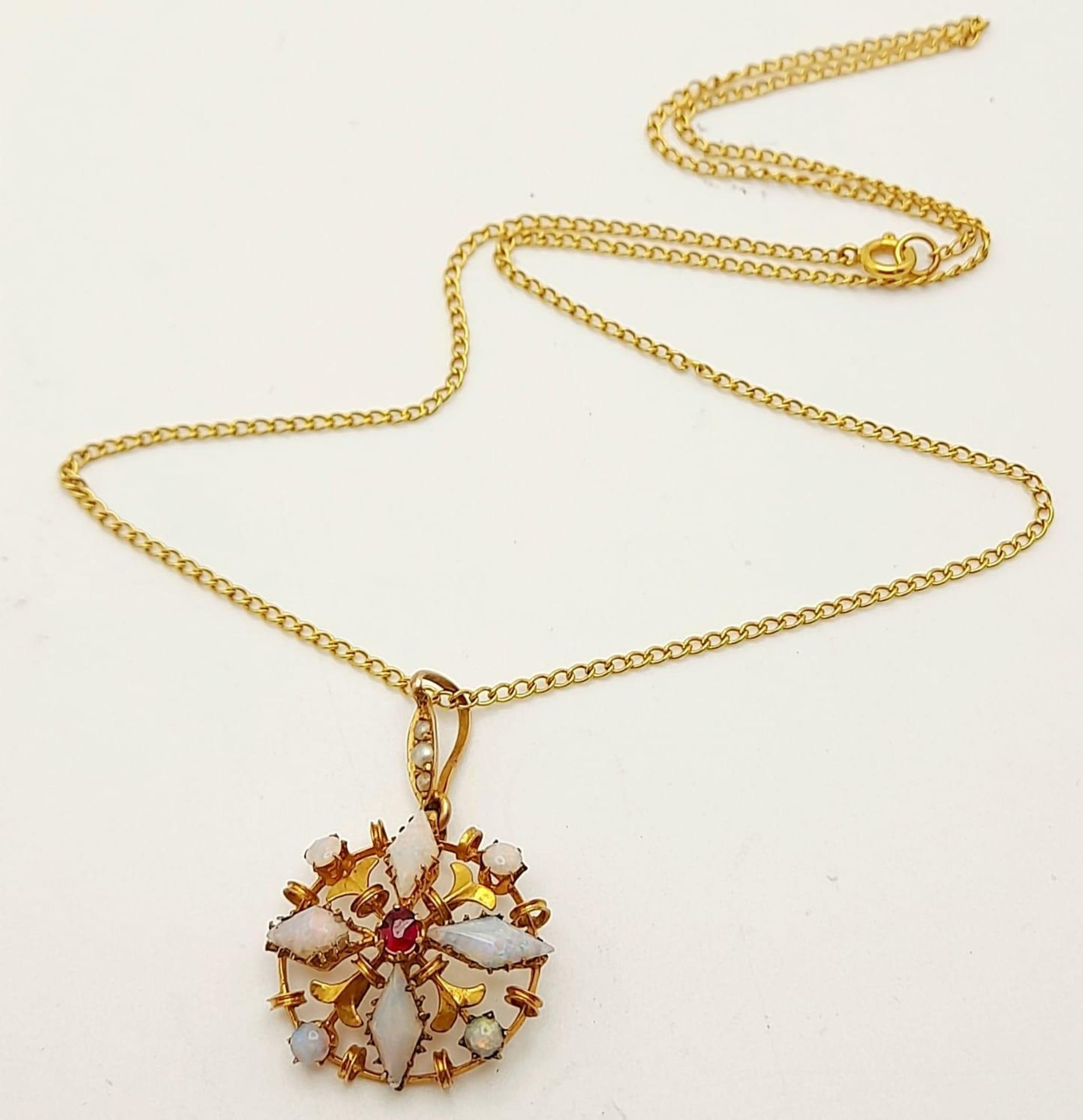 A 9K Yellow Gold and Opal Pendant on a 9K Yellow Gold Disappearing Necklace. Comes with a