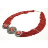 A Statement Multi-Strand Coral Necklace with a Trio of Discs. 1m length, 241.20g total weight.