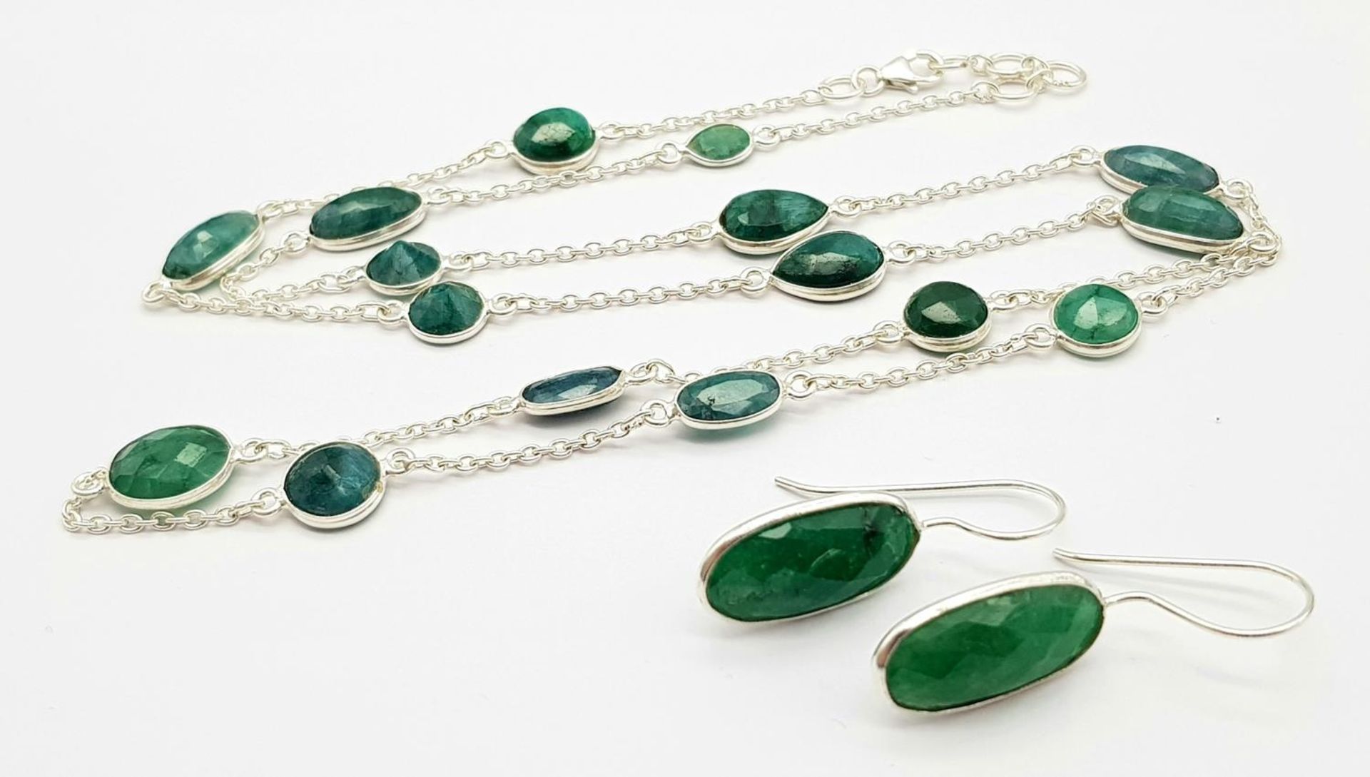 An Emerald Gemstone Long Chain necklace with Matching Drop Earrings. Set in 925 silver. 64cm