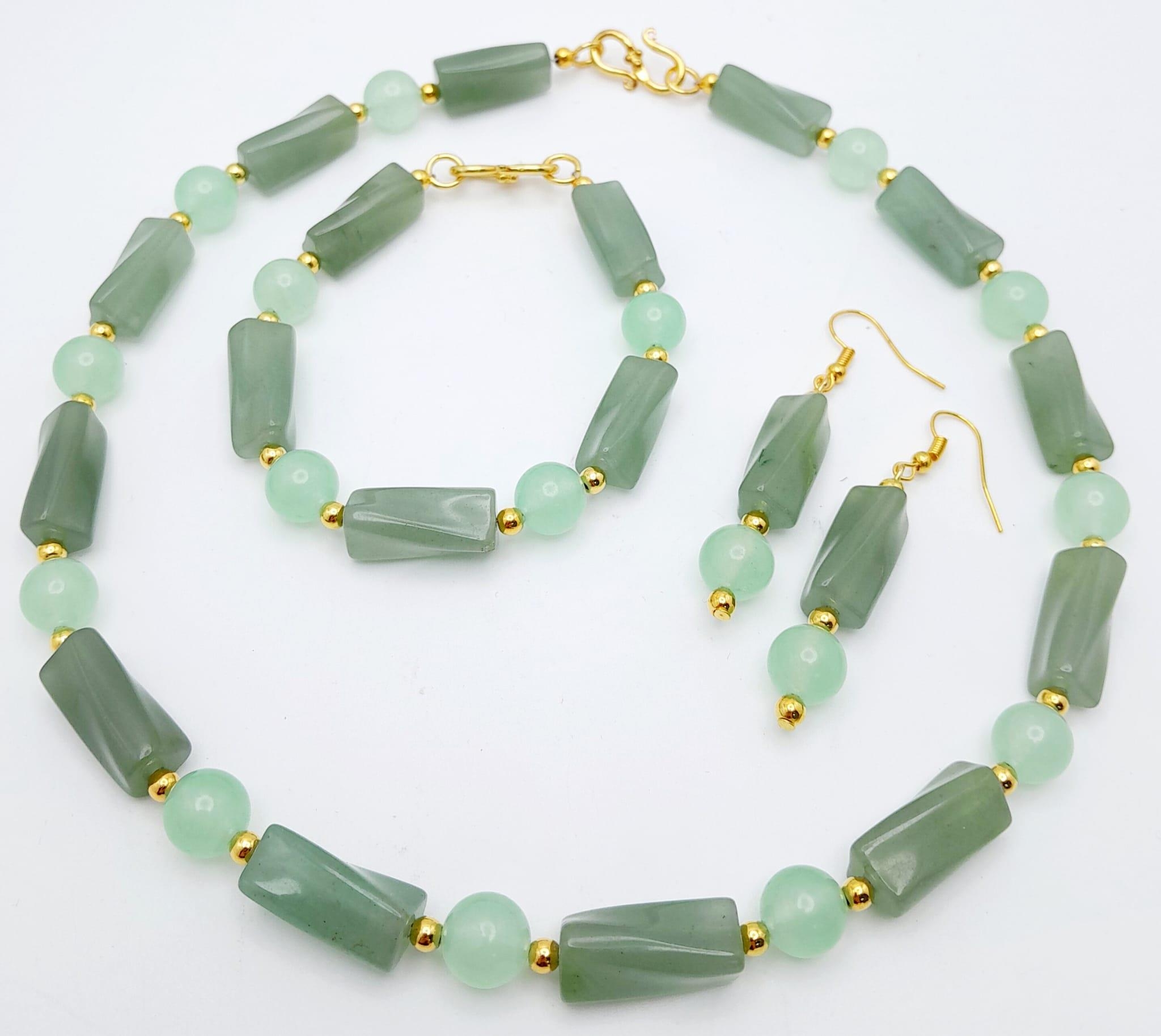 A high-quality light green, semi-translucent, jade necklace, bracelet and earrings set. Necklace