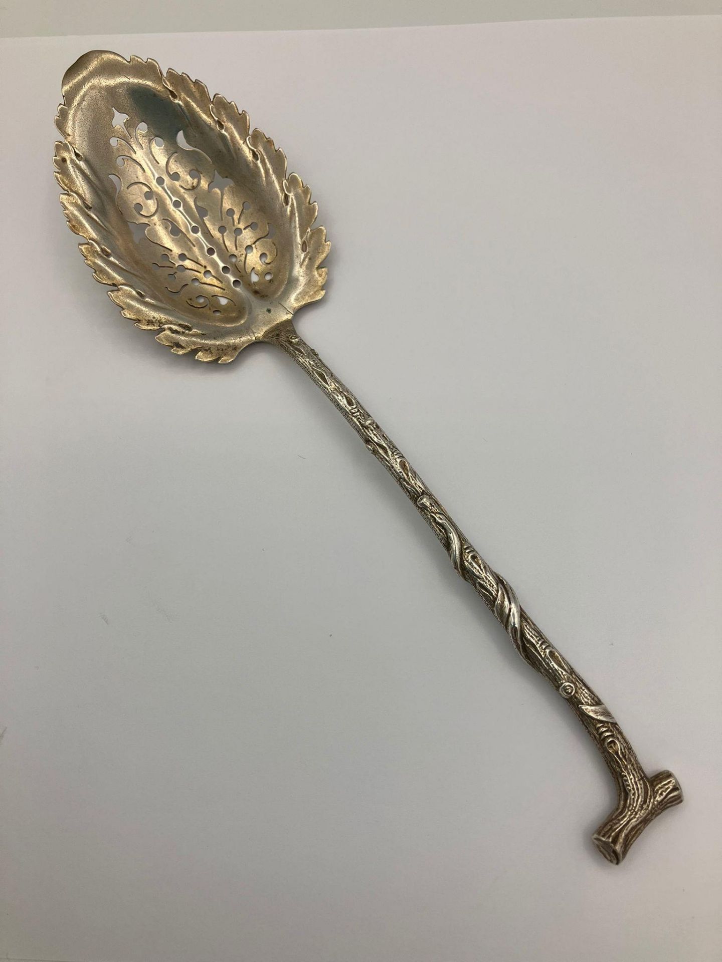 Rare Antique SILVER SIFTING SPOON in the shape of a branch.Having a leaf design bowl with a twig