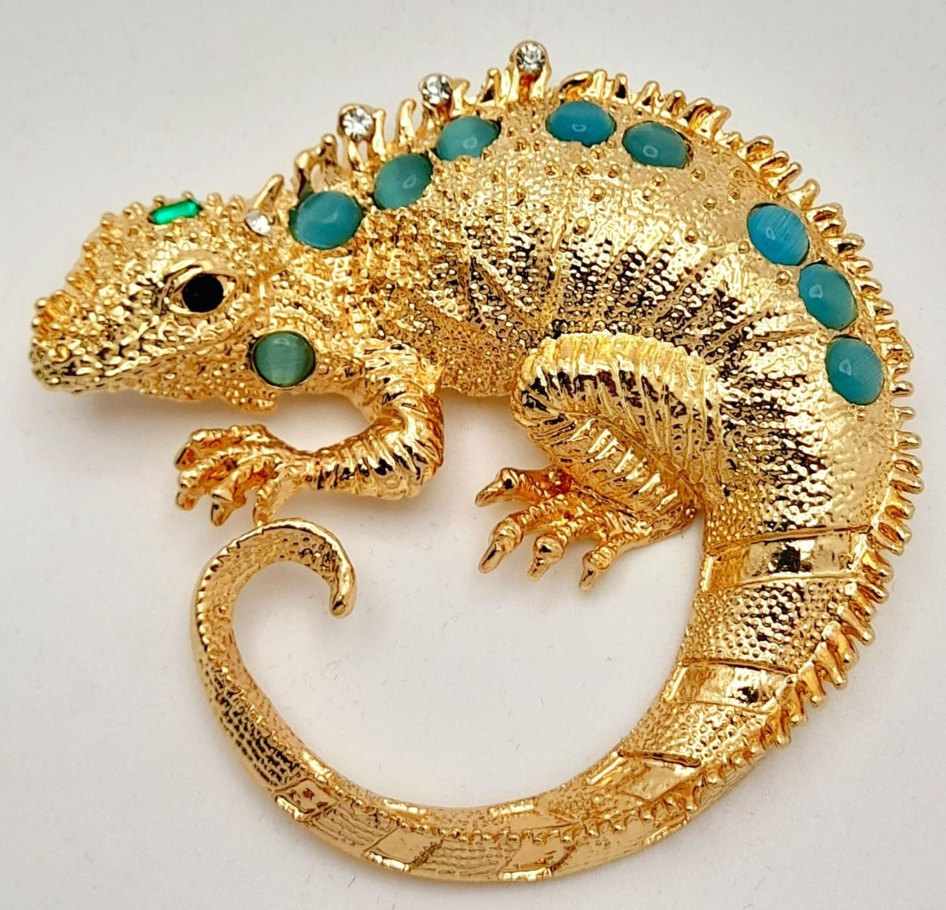 A very glamorous, well proportioned, gold plated and gem studded chameleon brooch, in a presentation
