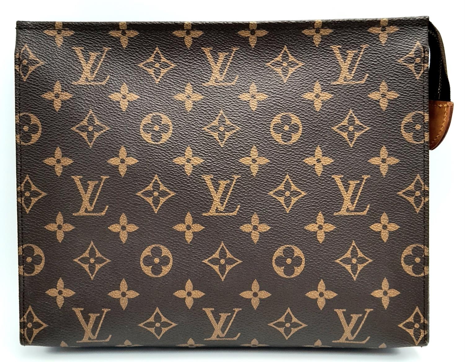 A Louis Vuitton Toiletries Pouch. Monogramed canvas exterior with gold-toned hardware and zipped top