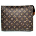 A Louis Vuitton Toiletries Pouch. Monogramed canvas exterior with gold-toned hardware and zipped top