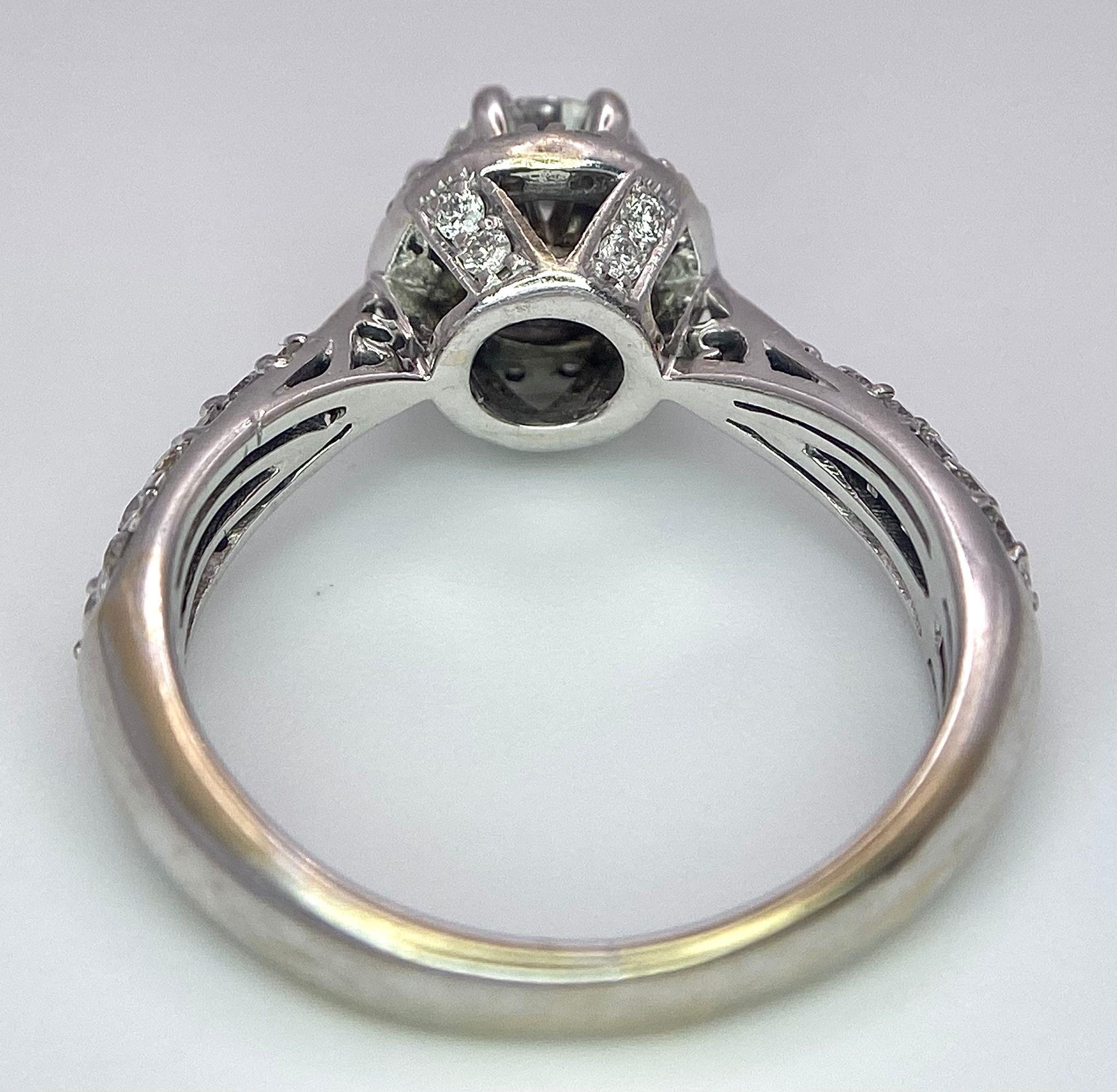 An 18K White Gold Diamond Ring. Central 0.75ct brilliant round cut diamond with a diamond halo and - Image 7 of 10