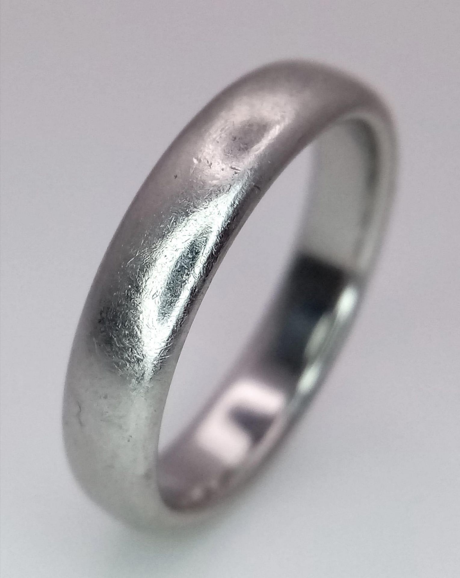 A Tiffany and Co Platinum 4mm rounded band ring. 9.3g. Size Q.