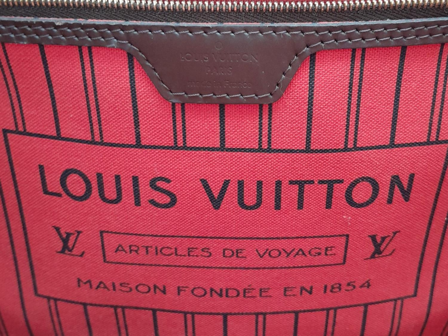 A Louis Vuitton Neverfull Damier Ebene Bag. Coated canvas exterior with leather trim, gold-toned - Image 11 of 12
