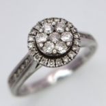 A 9K White Gold Diamond Cluster Ring. Decorative floral shape. Size N. 4g total weight.