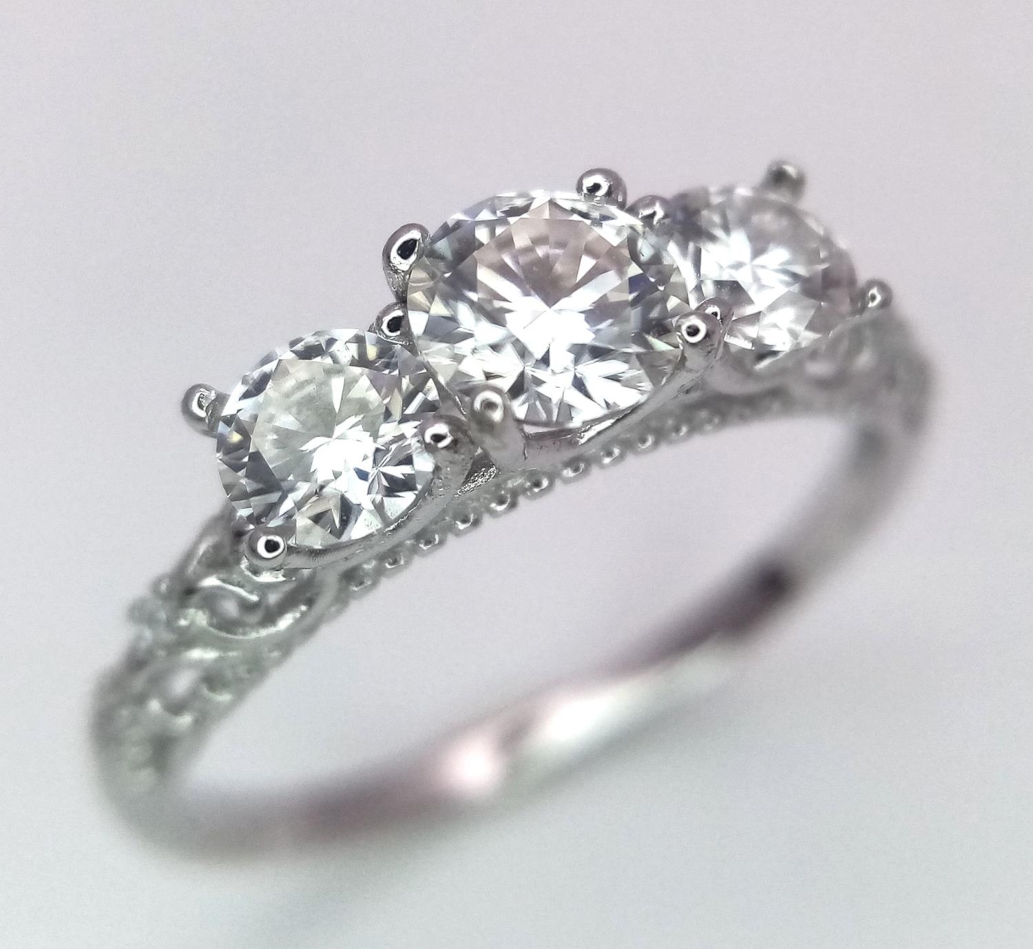 A 0.5ct Three Stone Moissanite, 925 Silver Ring. Size N. Comes with a GRA cert.