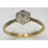 An 18K Yellow Gold, Platinum Diamond Ring. Size Q. Seven old cut diamonds in a decorative floral