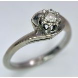 An 18K White Gold Diamond Crossover Ring. 0.10ct brilliant round cut diamond. Size N. 4g total