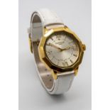 A Gamages of London Quartz Ladies Watch. White leather strap. Gilded case - 38mm. Silver tone