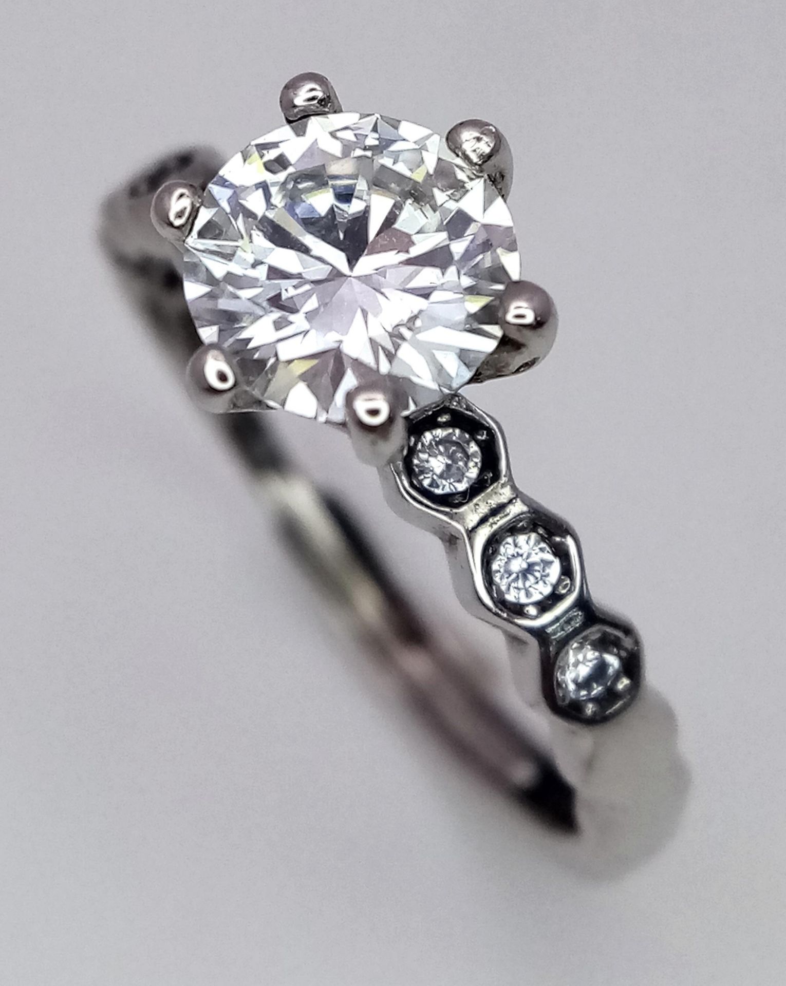 A 1ct Moissanite Ring set in 925 Silver. Comes with a GRA certificate. Size N.