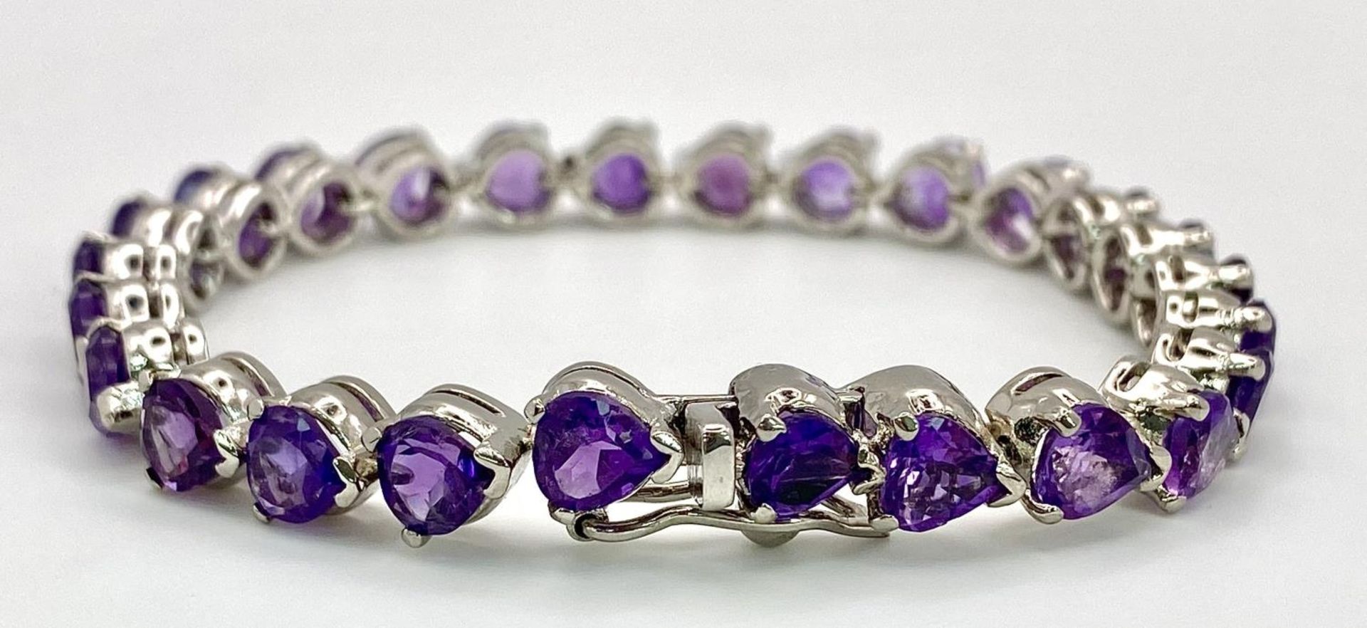 An Amethyst Gemstone Tennis Bracelet set in 925 Silver. Heart shaped amethysts. 18cm. 25g. Ref: CD- - Image 3 of 4