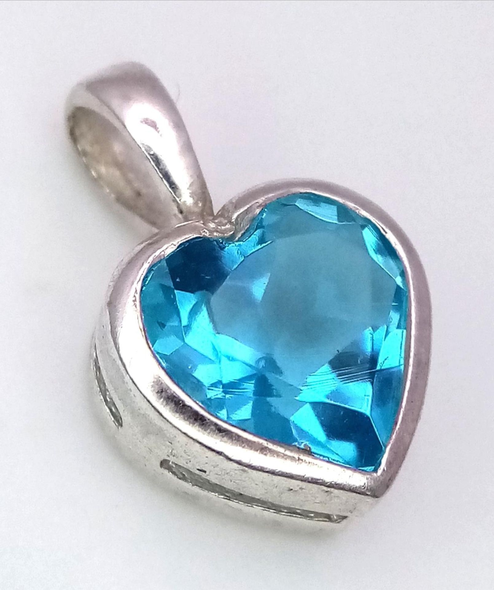 A Blue Topaz Heart Pendant on 925 Silver. 1.7cm length, 1.62g total weight.