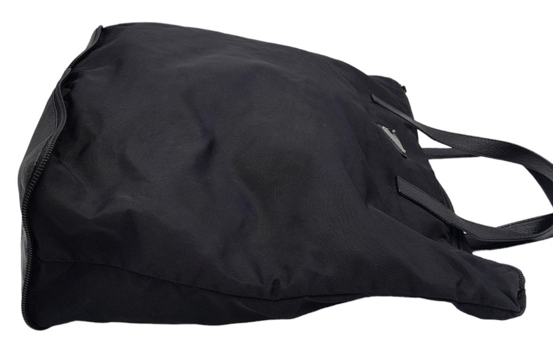 A Prada Black Compactable Tote Bag. Textile exterior with leather handles and zip top closure. Black - Bild 3 aus 12