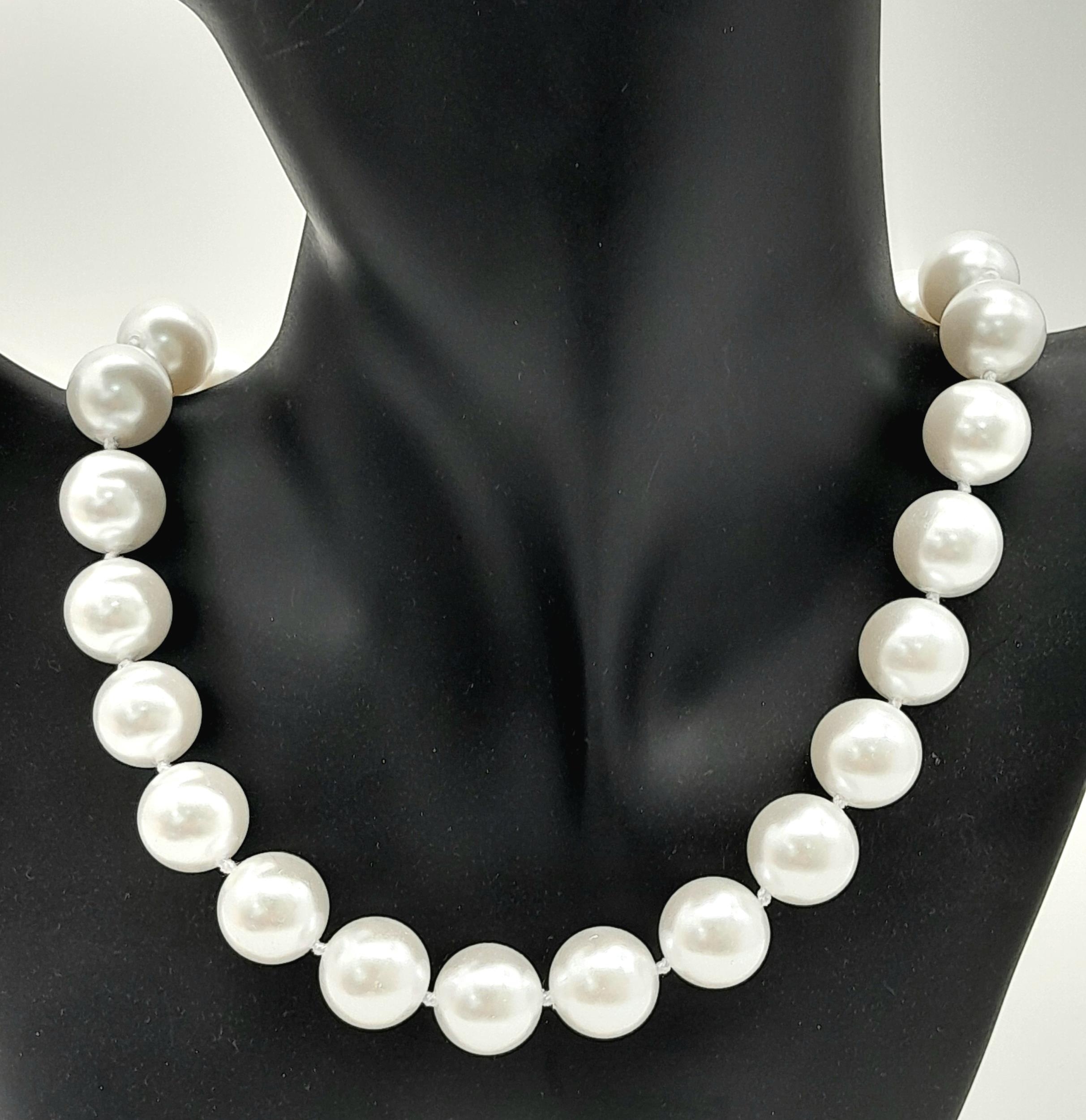 A Bright White South Sea Pearl Shell Bead Necklace. 14mm beads. 40cm. Gilded clasp.