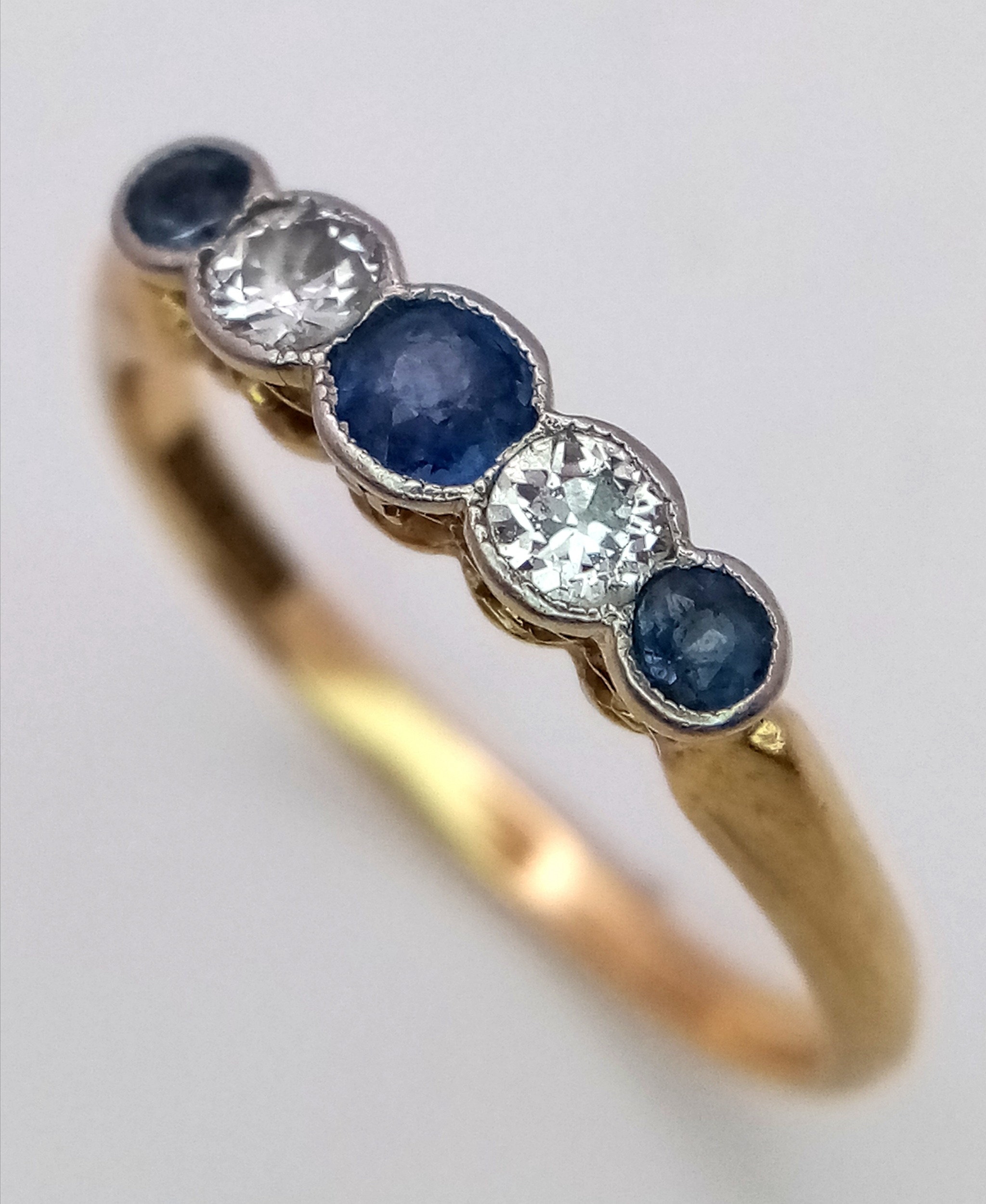 An 18K Gold (tested) Diamond and Pale Blue Sapphire Ring. Size O. 2.6g total weight. - Image 2 of 6