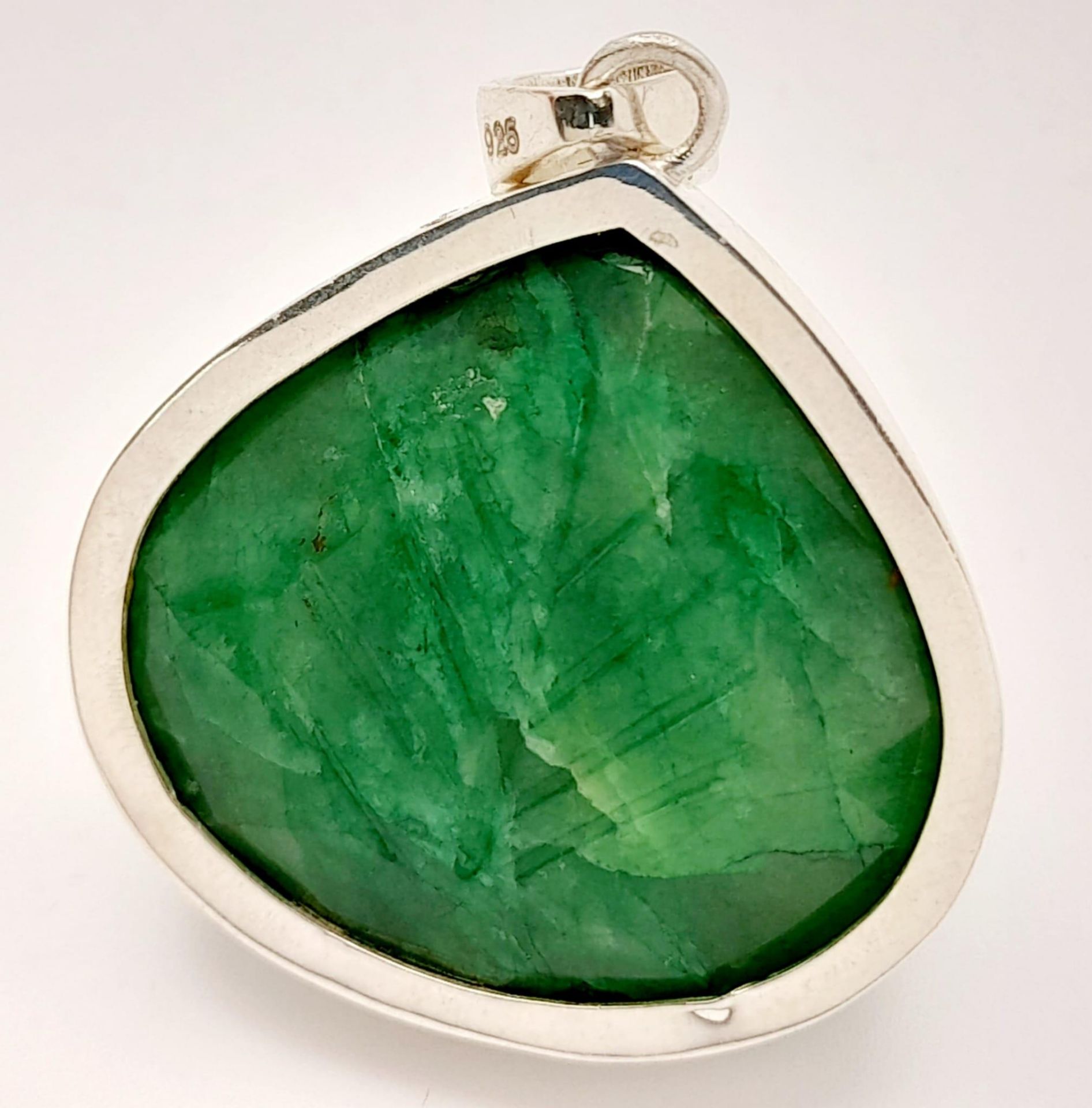 A Carved Trillion Shape 81ct Emerald Pendant set in 925 Silver. 4cm. Comes with a presentation case. - Image 2 of 6