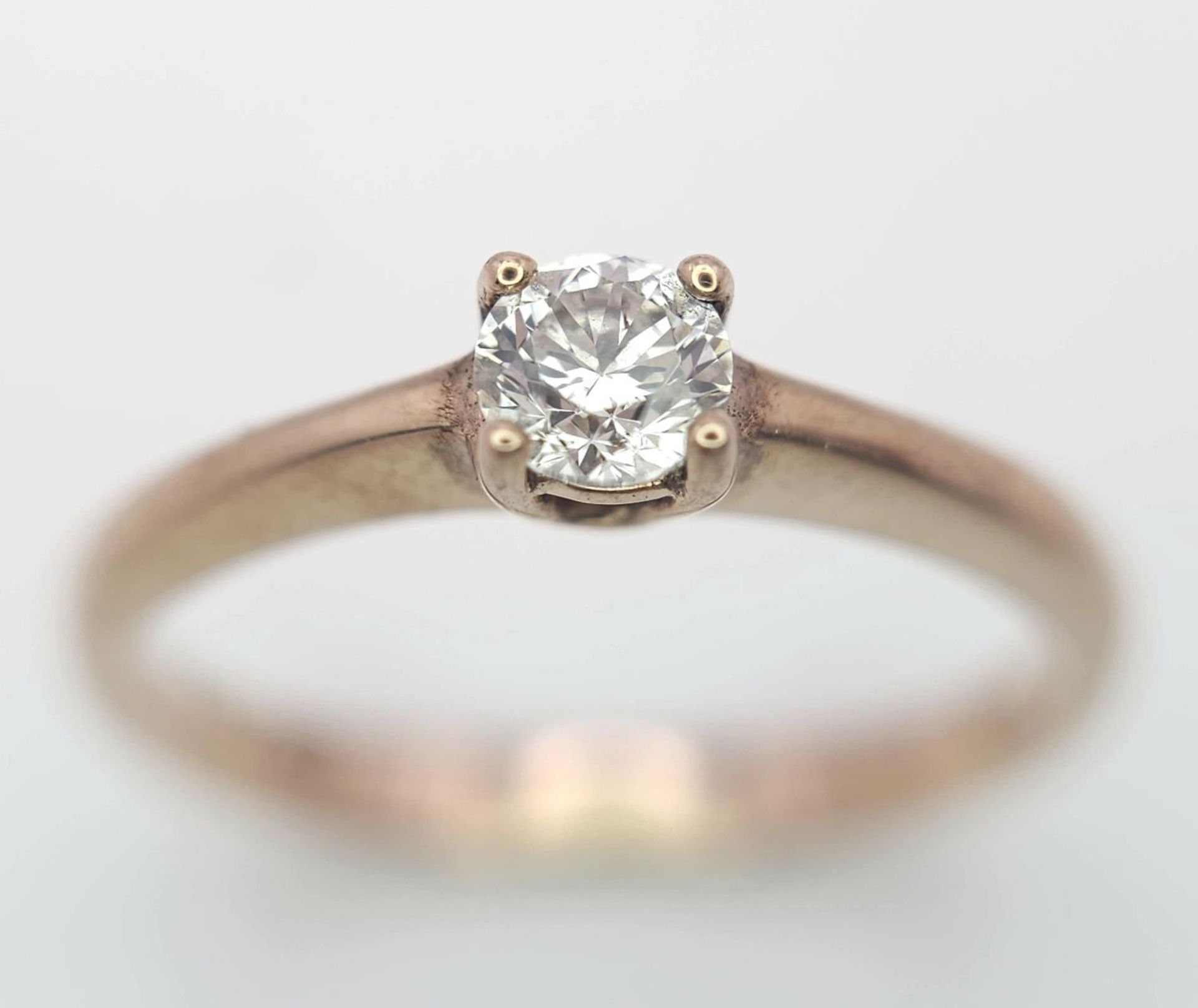 A 9K Rose Gold Diamond Solitaire Ring. 0.10ct round cut diamond. Size N. 2g total weight.