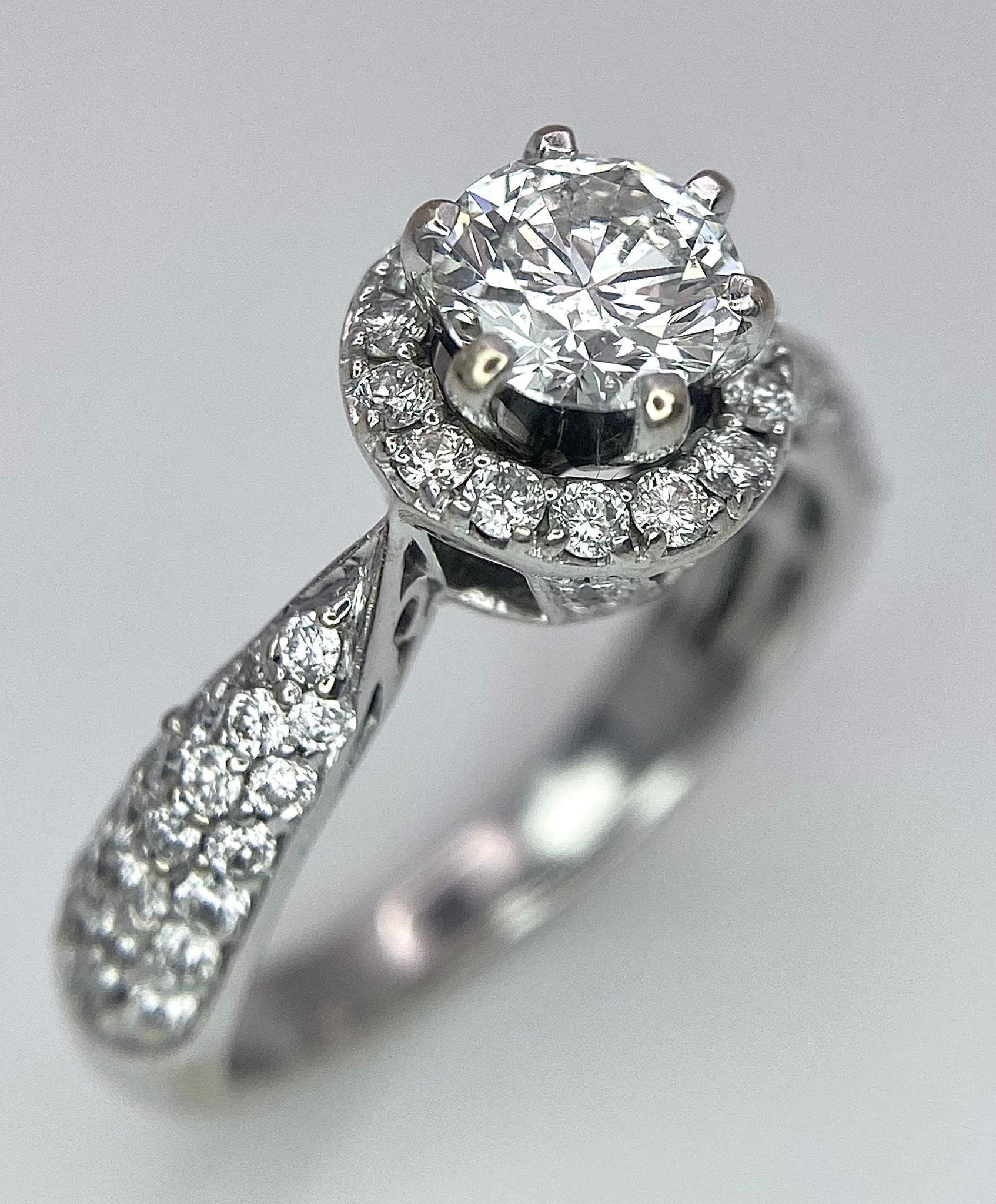 An 18K White Gold Diamond Ring. Central 0.75ct brilliant round cut diamond with a diamond halo and - Image 3 of 10
