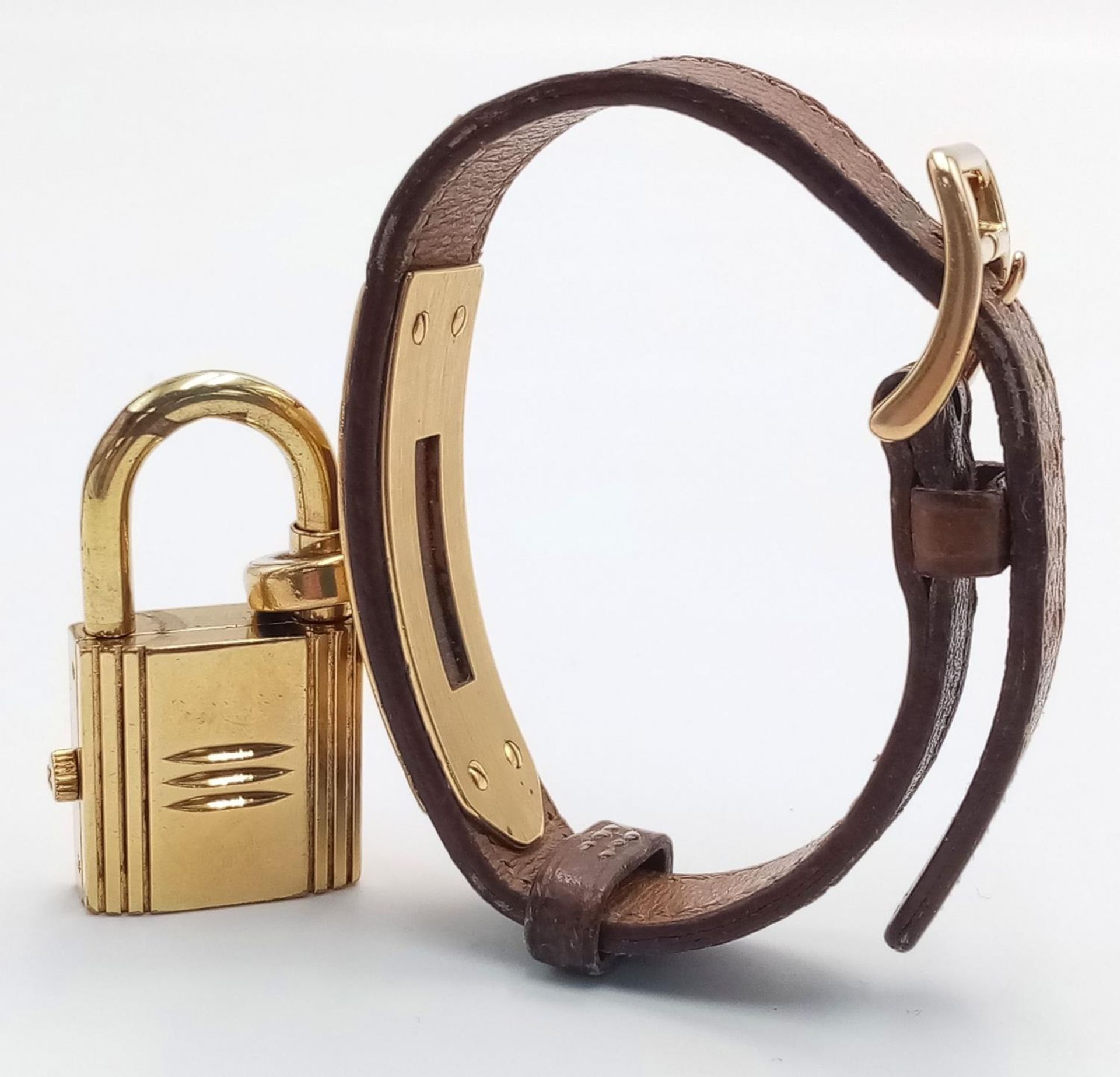 A Hermes Kelly Watch. Brown leather strap. Gold plated padlock quartz watch. Needs a battery so as - Image 2 of 7