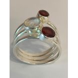 Impressive SILVER TRIPLE SHANK RING set with MOONSTONE and GARNETS. Presented in ring box. Size