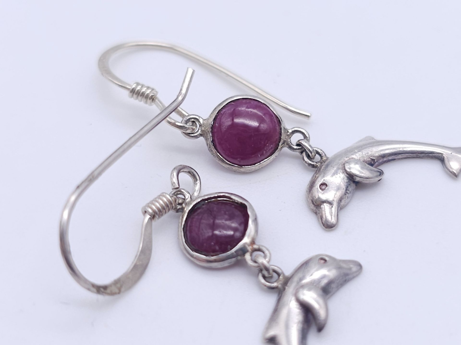 A Pair of Sterling Silver Ruby Set Dolphin Pendant Earrings. 2.5cm Drop. Set with 5mm Round Cut Ruby - Image 3 of 5