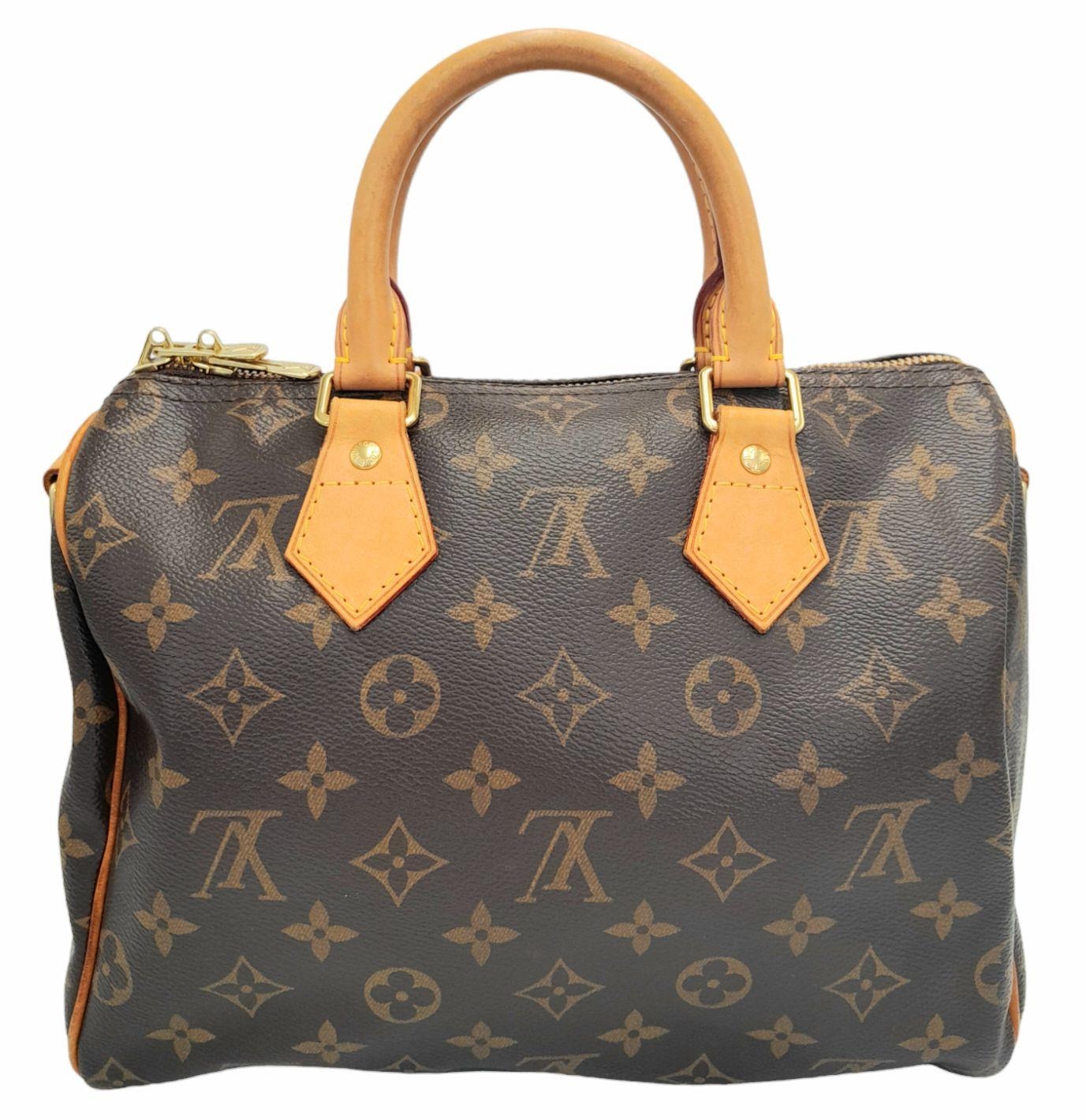 A Louis Vuitton Speedy Bag. Monogramed canvas exterior with gold-toned hardware, two rolled - Image 2 of 12