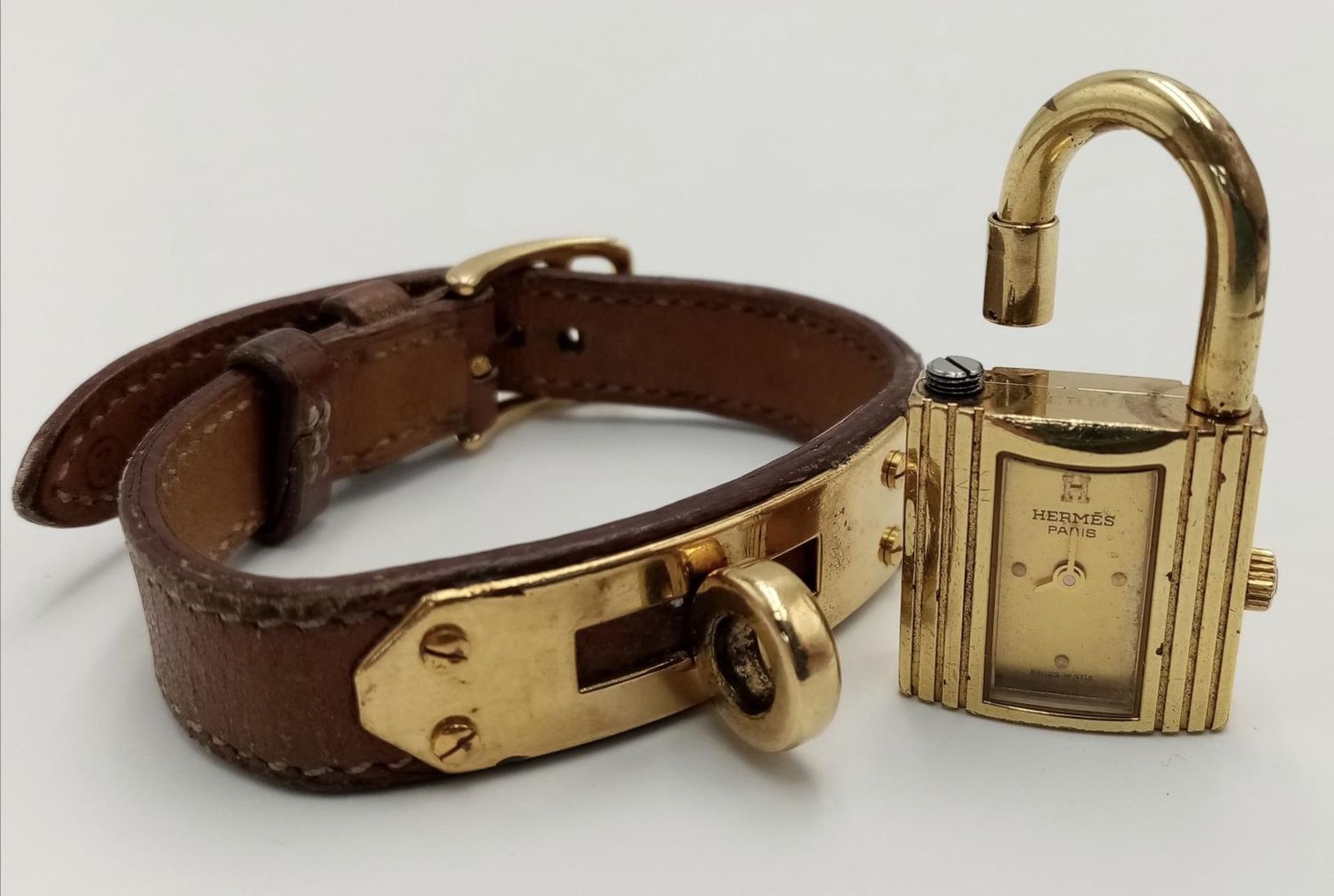 A Hermes Kelly Watch. Brown leather strap. Gold plated padlock quartz watch. Needs a battery so as - Image 4 of 7