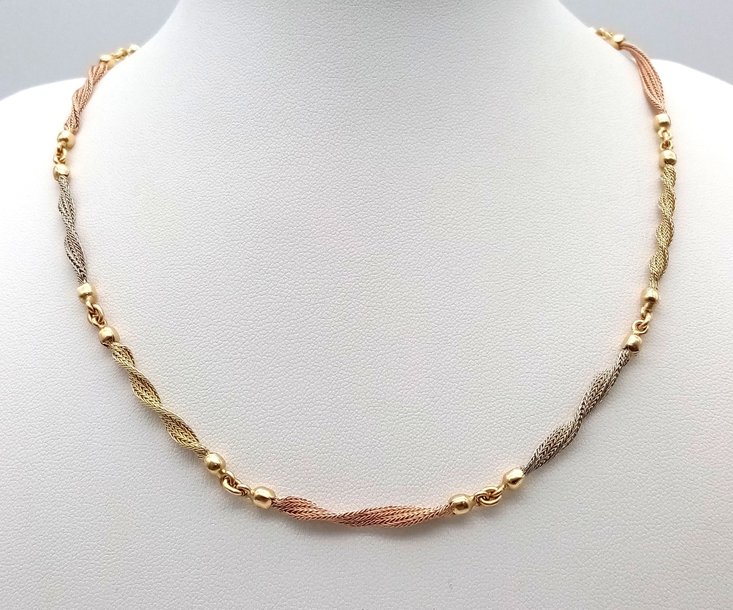 A Beautiful Italian 14K Yellow and Rose Gold Twist Necklace. Ten bars of alternating coloured gold