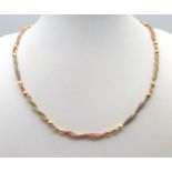 A Beautiful Italian 14K Yellow and Rose Gold Twist Necklace. Ten bars of alternating coloured gold