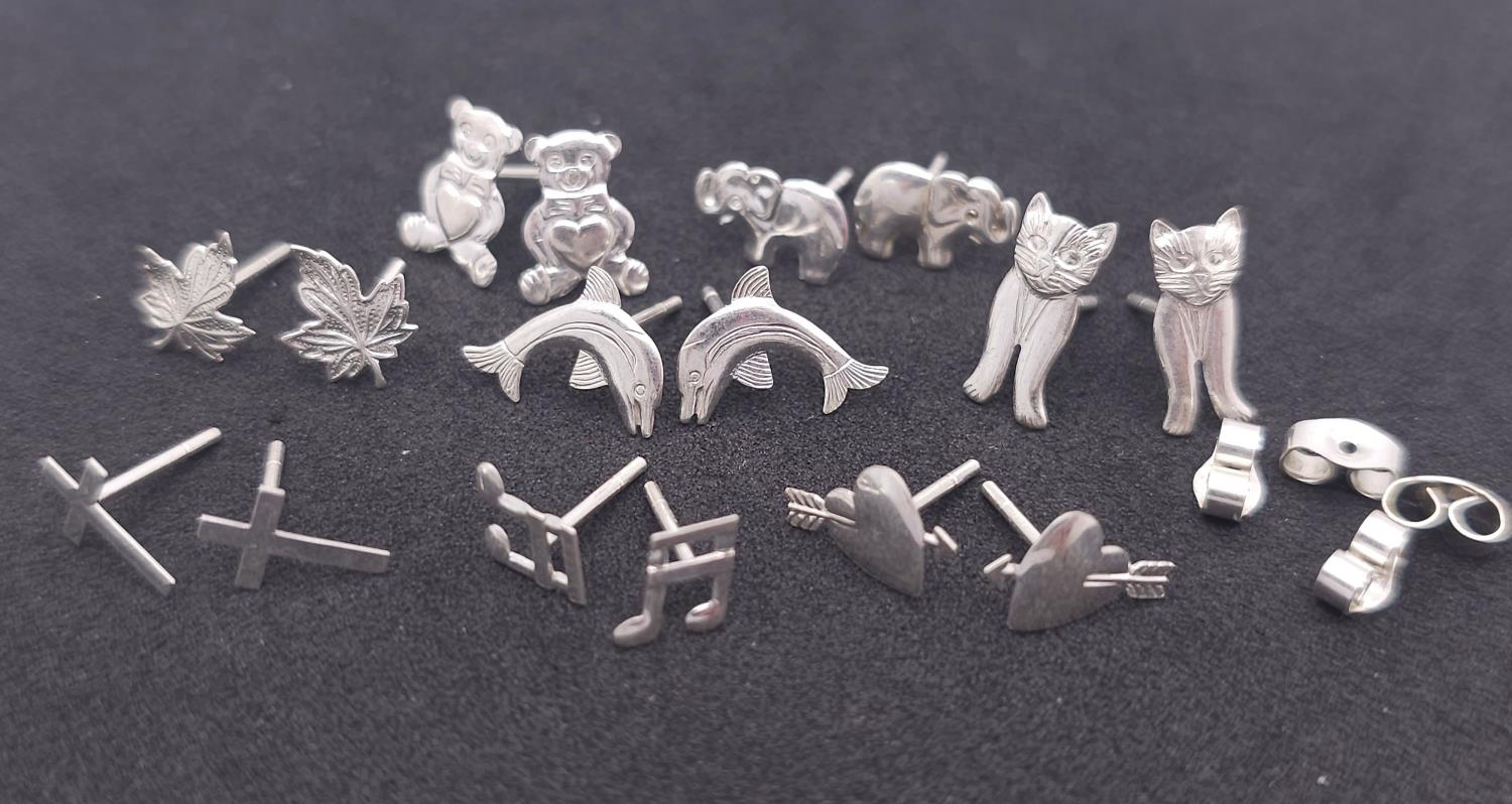 A LOT TO INCLUDE 8 PAIRS OF STERLING SILVER STUD EARRINGS ELEPHANTS, HEARTS, CROSS, LEAF, MUSIC