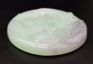 A Chinese Pale Green and White Jade Circular Pendant with Village Decoration. 5cm diameter.
