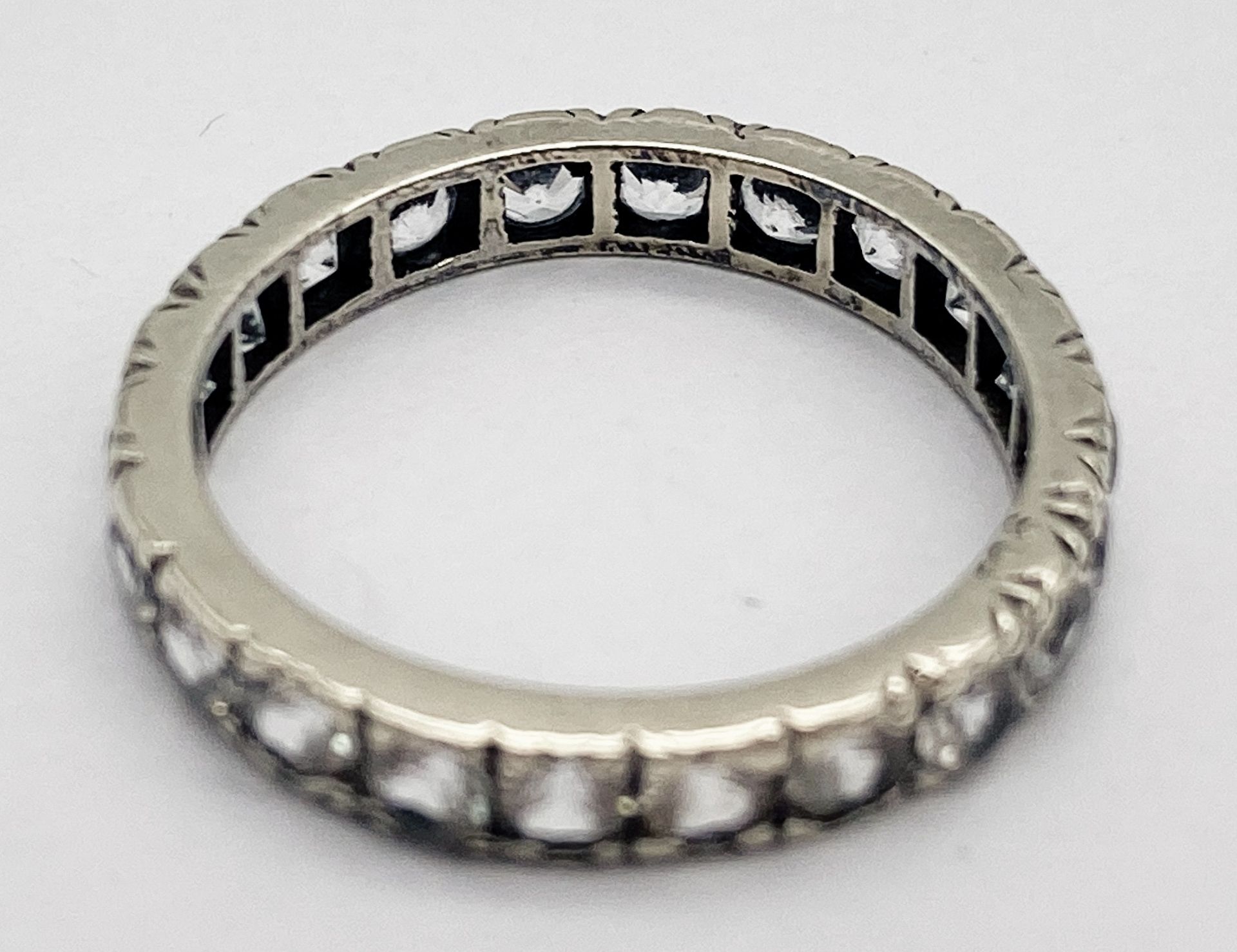 A VINTAGE 9K WHITE GOLD (TESTED) WHITE STONE FULL ETERNITY RING. 2.5G. SIZE 0. - Image 4 of 6
