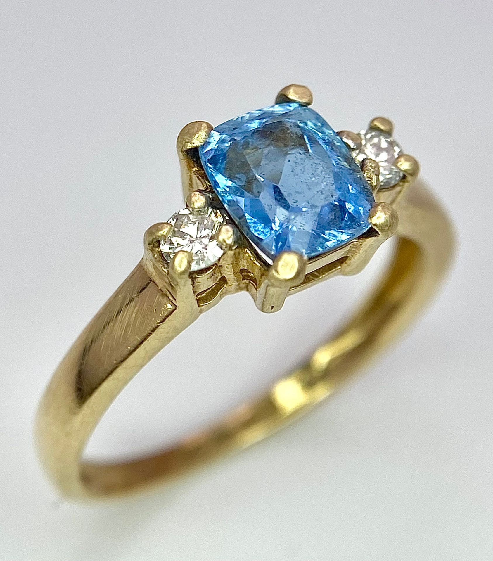 A 9K Yellow Gold Aquamarine and Diamond Ring. Size M, 2.14g total weight.