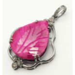 A Hand-Carved Ruby Gemstone with Diamond Accent Pendant. Pear shaped ruby - 30ct and diamond