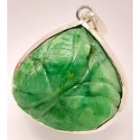 A Carved Trillion Shape 81ct Emerald Pendant set in 925 Silver. 4cm. Comes with a presentation case.