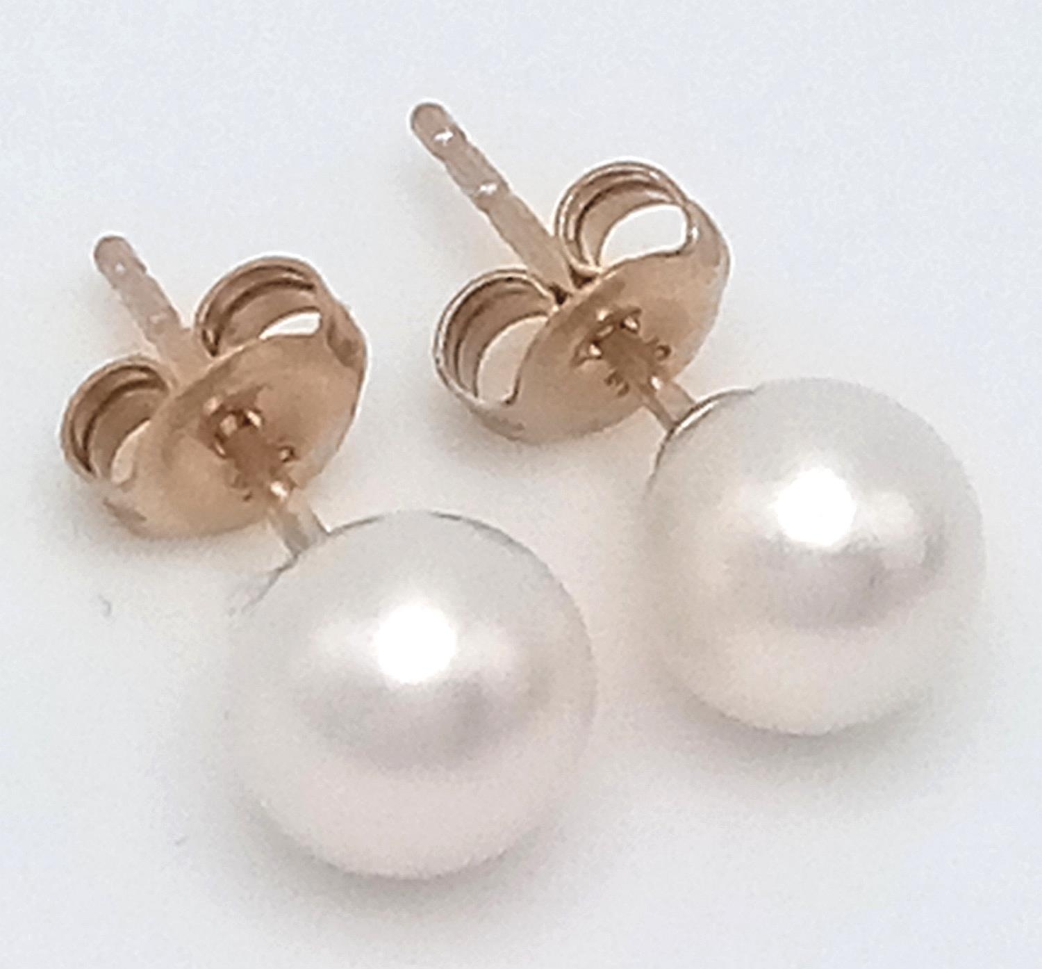 A Pair of 9K Yellow Gold Cultured Pearl Stud Earrings. In box.