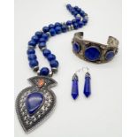 A Lapis Lazuli Jewellery Suite: Cuff bangle, necklace and earrings. 48cm length.