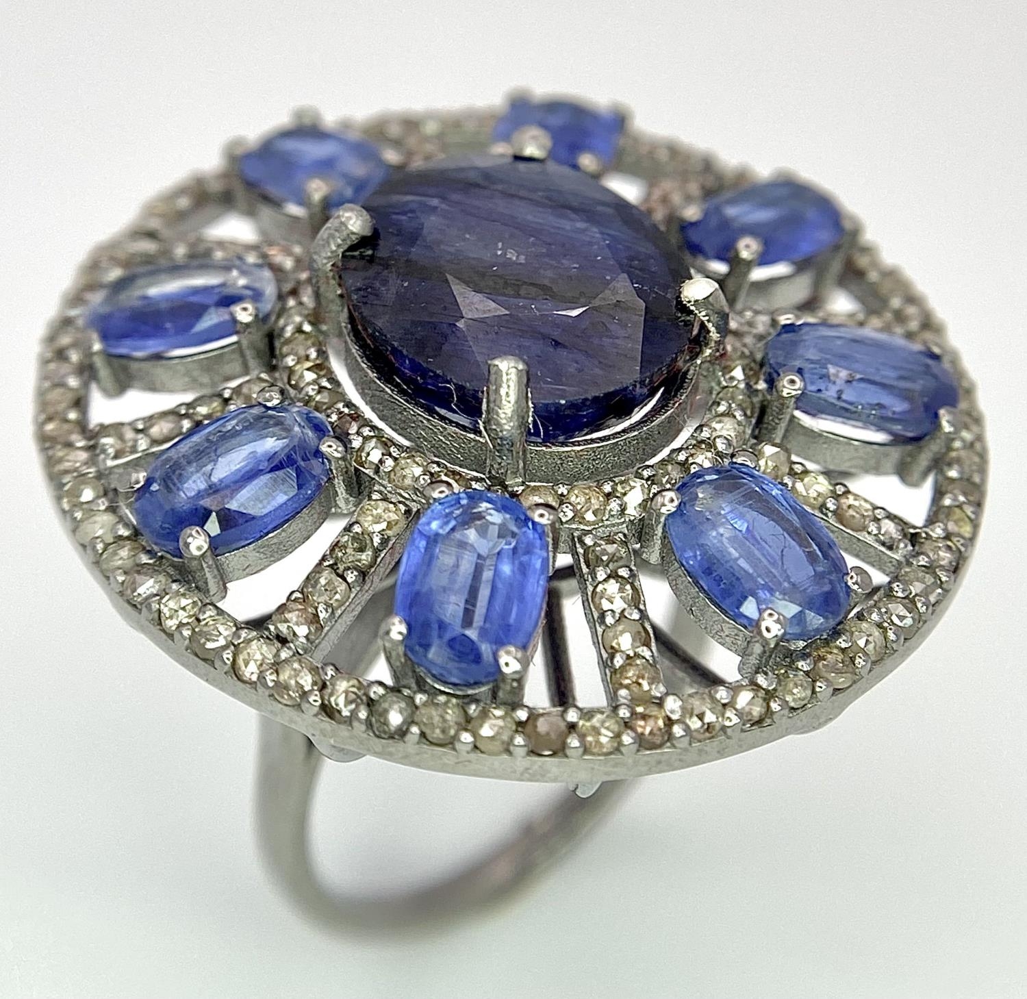 A 10ct Topaz Ring with 6.15ctw of Kyanite surround and 0.50ctw of Diamond Accents. Set in 925