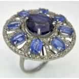 A 10ct Topaz Ring with 6.15ctw of Kyanite surround and 0.50ctw of Diamond Accents. Set in 925