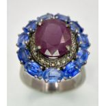 A 5.65ct Ruby Dress Ring with Halo of 0.40ctw of Diamonds and 3.70ct of Kyanite Stones. Set in 925