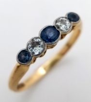 An 18K Gold (tested) Diamond and Pale Blue Sapphire Ring. Size O. 2.6g total weight.