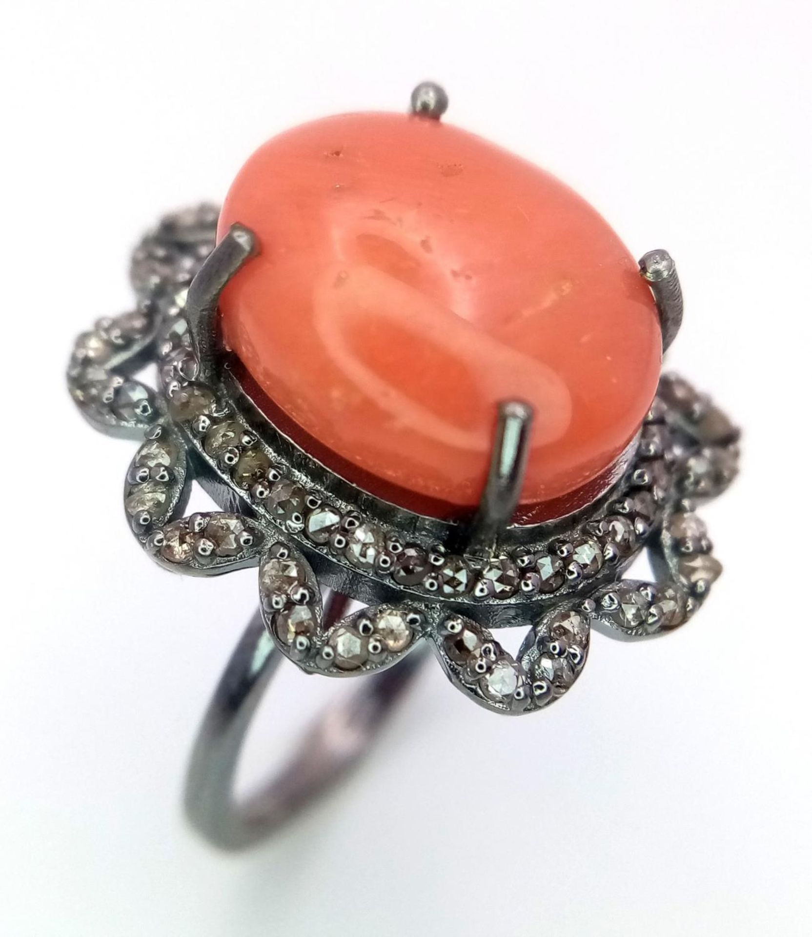 A 6.5ct Coral and Diamond Ring. A coral cabochon with 0.75ctw of Diamond Accents. Size M. Ref: Cd-