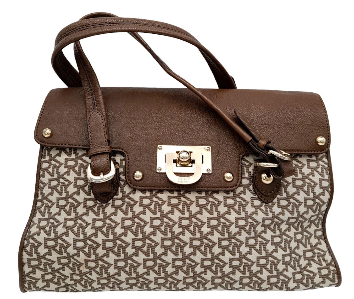 A DKNY Brown Satchel Bag. Canvas and leather exterior with gold-toned hardware, four protective base - Image 2 of 10