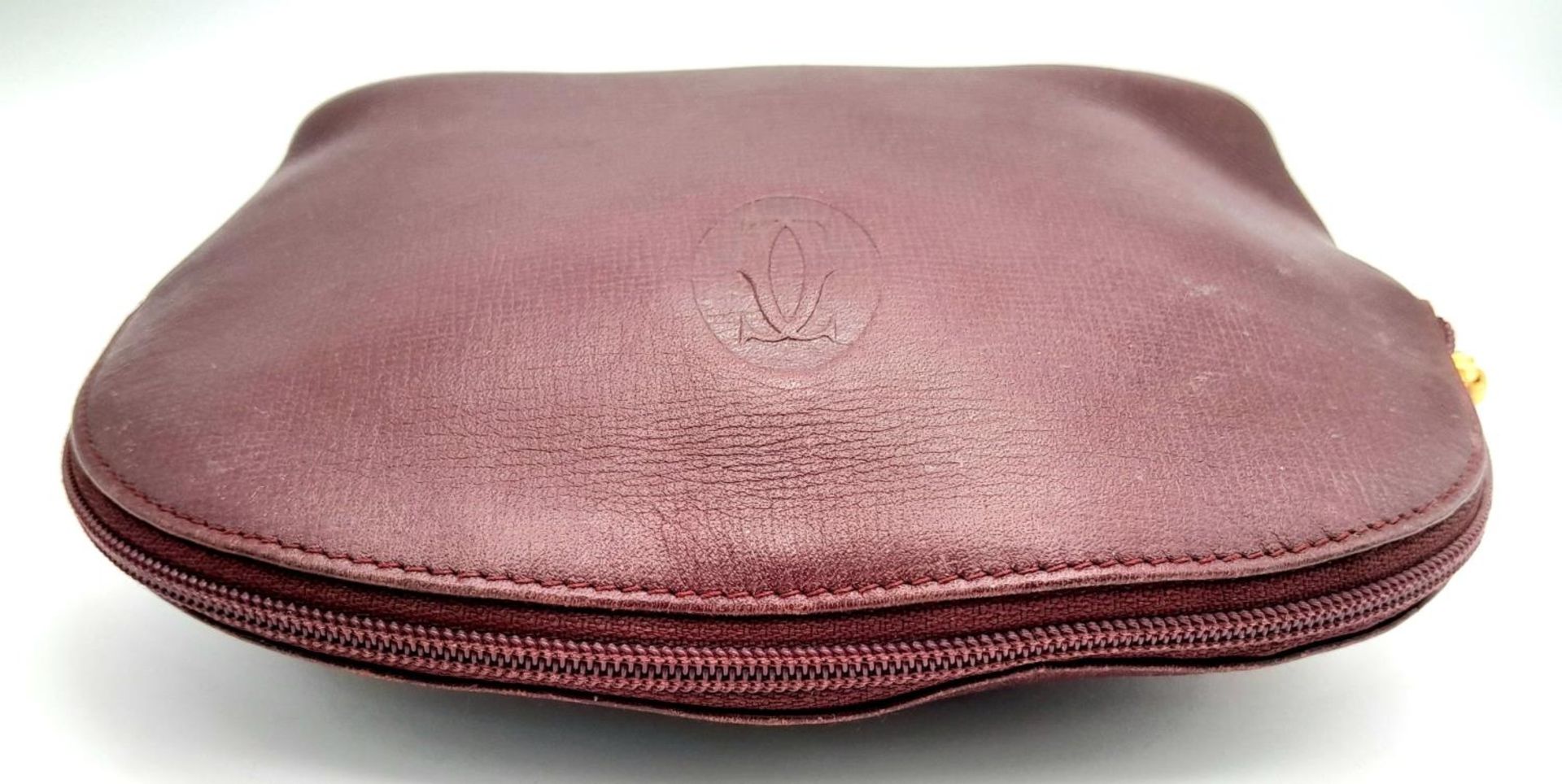 A Vintage Cartier Burgundy Pouch. Leather exterior with zip top closure. Burgundy canvas interior. - Image 4 of 11