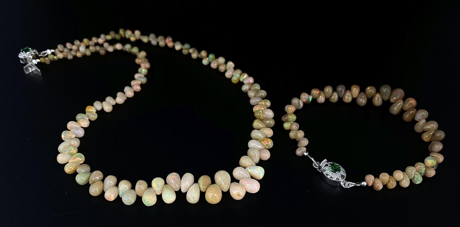 A 120ctw Opal Gemstone Necklace with Matching Bracelet. 925 Silver and emerald clasp. 44cm and 16cm.
